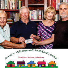 Lloyd Maritz of The Variety Show and Bill Trapp of The SaddleBrooke Theatre Guild hand a donation check to Steve and Susan Shear, founding members of Senior Village at SaddleBrooke.