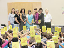 At Wilson Elementary School are (from left): Cathy Mikesell, Rachel McCoy, Debbie Price, Teri Pastor, Chris Champie, Marian Manning and Catalina Mountain Elks Dictionary Project Chairperson Joyce Garcia.