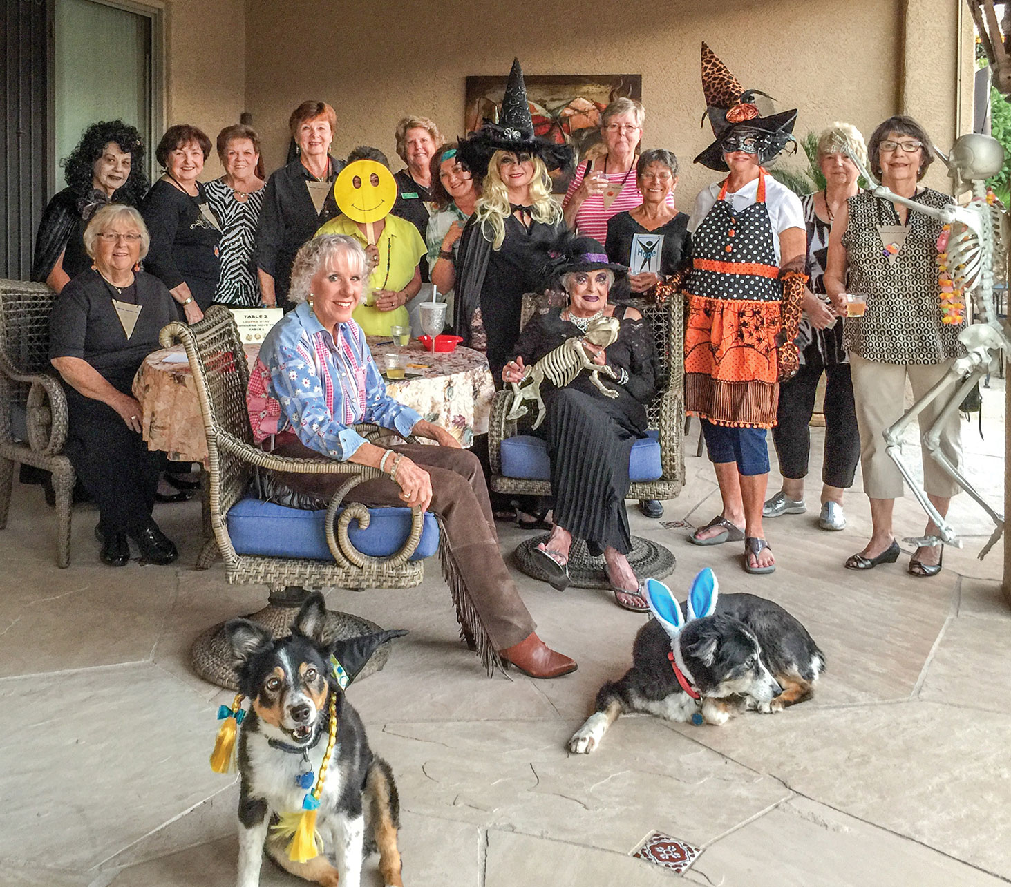 Despite many clever costumes, the ladies of Unit 21’s Bunco Group gathering just don’t look all that scary. The dogs, on the other hand, look like they would just like to go back to being man’s best friend!
