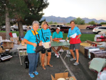 Workers Joan Elder, Marje and Frank Valenti and Laura Ingold sell and collect money.