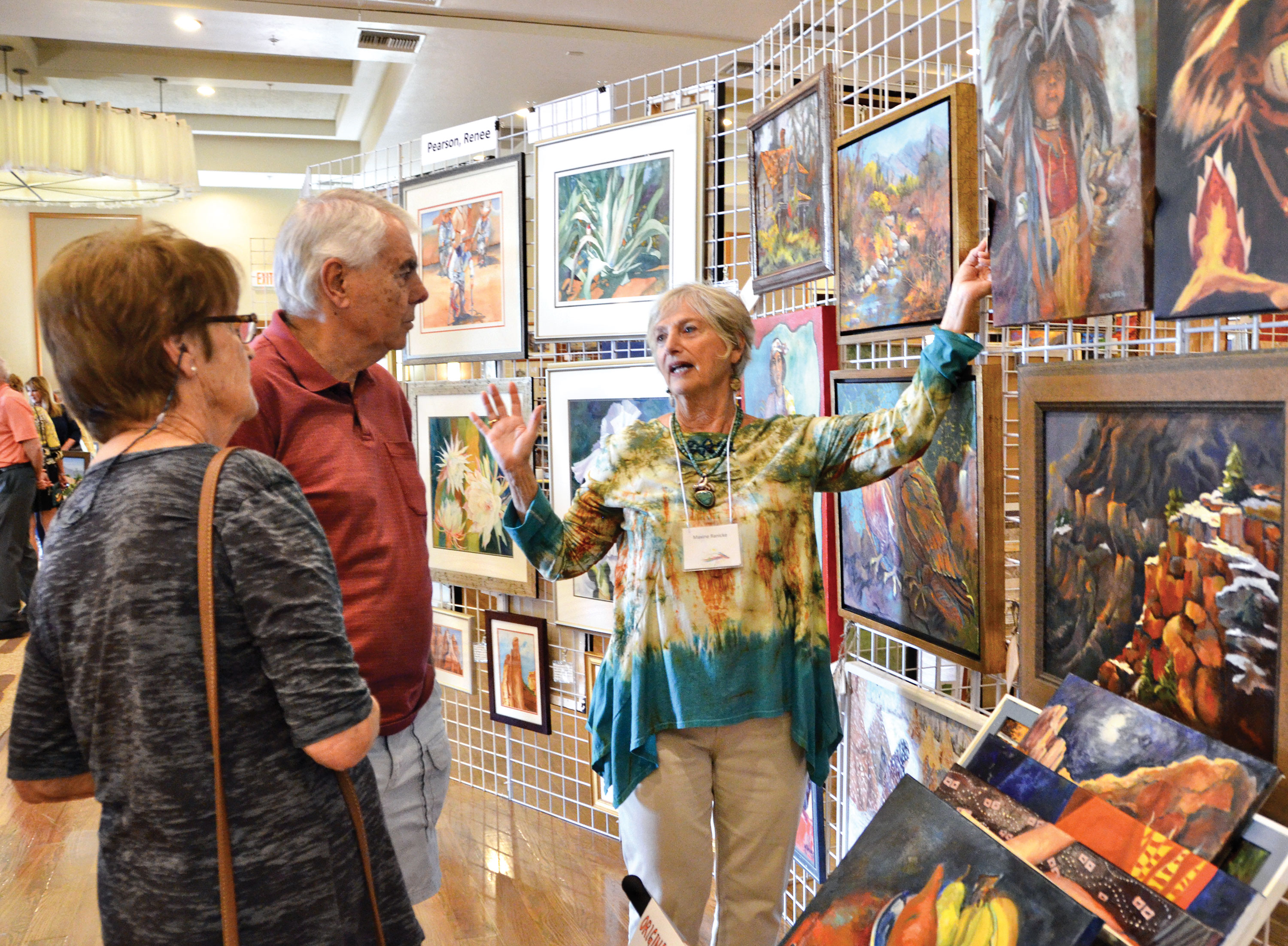 Artist Maxine Ranicke discusses her art with Chris and Margrit Wehrli.