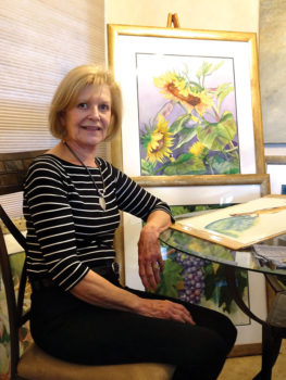 Renee Pearson pauses with a few of her watercolors.