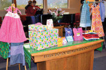 Some of the many items created by congregants of MSPC: dresses for African girls, gifts for the baby shower, Easter cards, hygiene bags for TCFB and a bundle of used clothing for the homeless.
