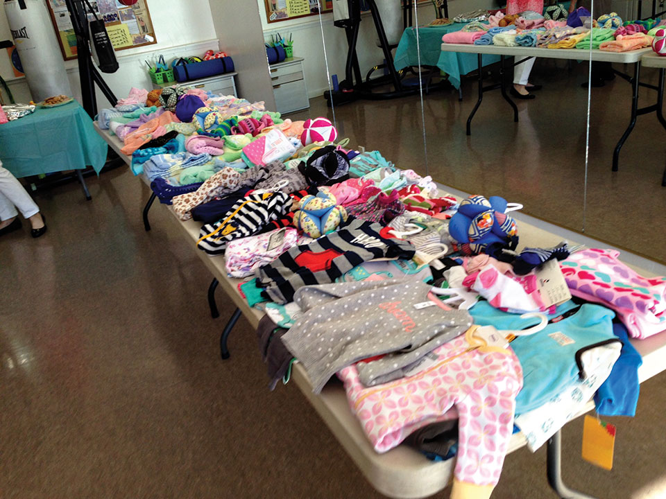 Another table loaded with knitted items and other donations