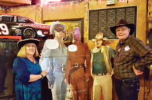 Sharon and Garrett Ressing pose with the Lone Ranger, Tonto and John Wayne.