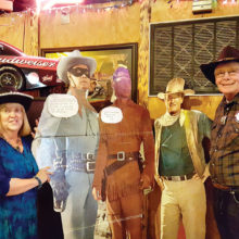 Sharon and Garrett Ressing pose with the Lone Ranger, Tonto and John Wayne.