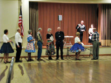 Student dancers line up for graduation ceremonies.