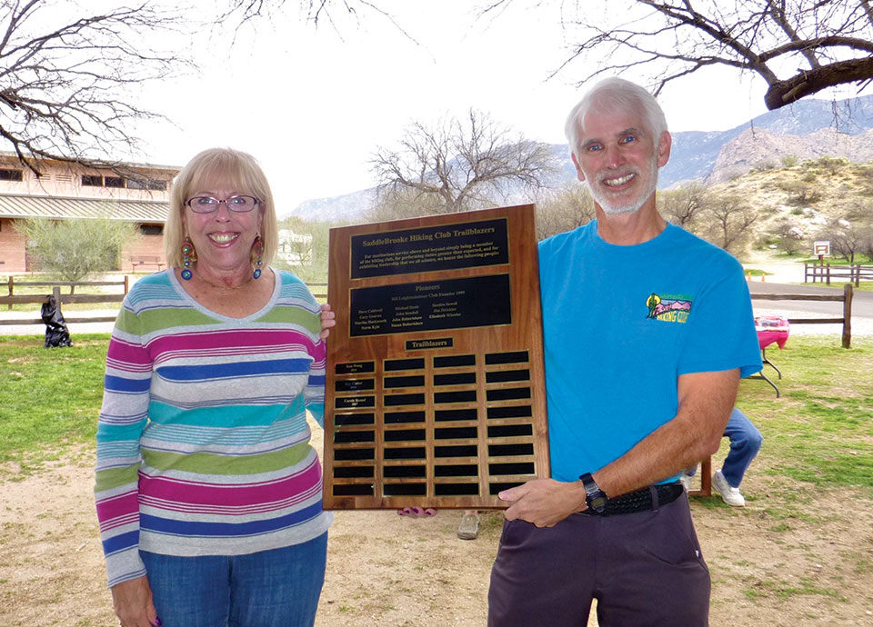 Randy Park honors volunteer Carole Rossof; her name is now engraved on the honor roll plaque outside the HOA 1 Golf Pro Shop; photo by Elisabeth Wheeler.