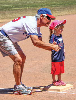 Quinn is ready to run home from third base with encouragement from Grandpa/Coach Terry Mihora; photo by Jim Smith.