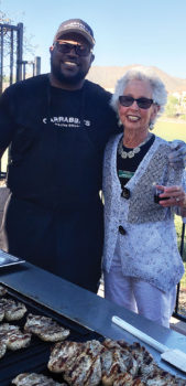 Jeff Berry, Carrabba’s, and Bonnie Barazani, social chairman for The Preserve, grin while teasing the crowd with the tantalizing aroma of almost ready Chicken Marsala.