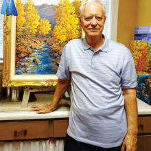 Mick Desmarais displays his first-place oil painting Sabino Canyon Autumn Splendor.