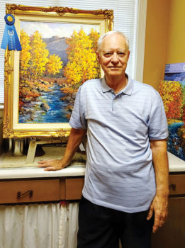 Mick Desmarais displays his first-place oil painting Sabino Canyon Autumn Splendor.