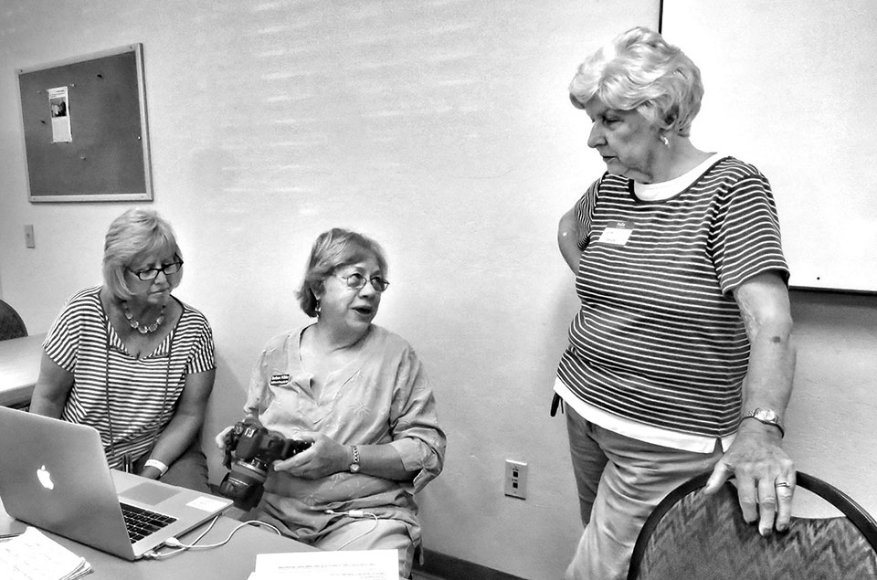 Jeannie Hayward, Barbara Wilder and JoAnn Koblewski talking about cameras; photo by Bill Grinonneau