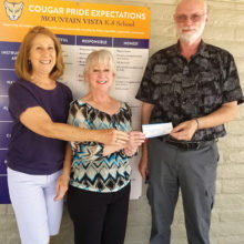 Marcia Schima and Mark Erickson present check to Darlene Cavanaugh (Oracle’s Mountain Vista K-8 school librarian).