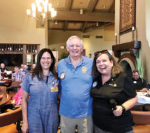 Left to right: Assistant Governor Mary Strauss assists outgoing President Doug May as he passes the gavel to the incoming president, Barbara Barr.