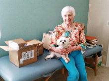 Senior Village member Marjorie Porta and Sasha take a break from downsizing her home.