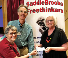 Randy and Barbara give a check to Tri Community Food Bank.