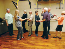 Roger and Linda Shamburg, Charla Blacker, Dan Eggleston, Peg and Joe Tomlinson, Dick Dunbar, and Bertie Litchfield practicing their dance lesson.