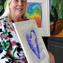 Theresa Poalucci displays work from her “Hearts” series of alcohol ink paintings.