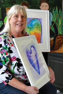 Theresa Poalucci displays work from her “Hearts” series of alcohol ink paintings.