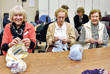 Caroline Serle, Helen Phillips, and Eileen Bartsch (left to right) enjoy visiting as their needles click.