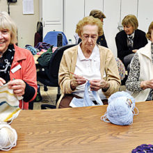 Caroline Serle, Helen Phillips, and Eileen Bartsch (left to right) enjoy visiting as their needles click.
