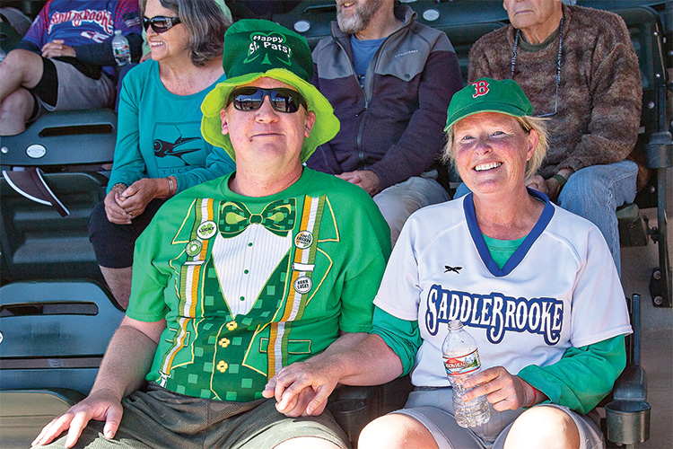 Jason Noffsinger and Sue O’Donnell enjoy the action at SaddleBrooke Senior Softball's annual St. Patrick’s Day Tournament. (Photo by Dennis Purcell)