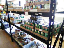 At the Tri-Community Food Bank, located in Mammoth, volunteers unload products and place them on shelves for easy access.