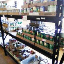 At the Tri-Community Food Bank, located in Mammoth, volunteers unload products and place them on shelves for easy access.