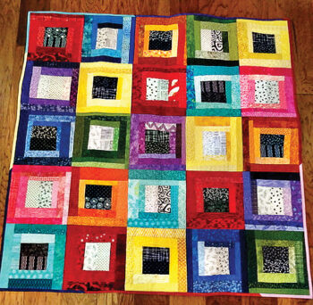 Scrap quilt Kris made to play with color against black and white patterns.