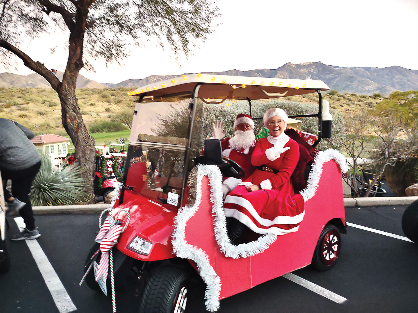 Kathy and Steve Sanchez in their winning holiday decorated golf cart (Photo by Bob Koblewski)