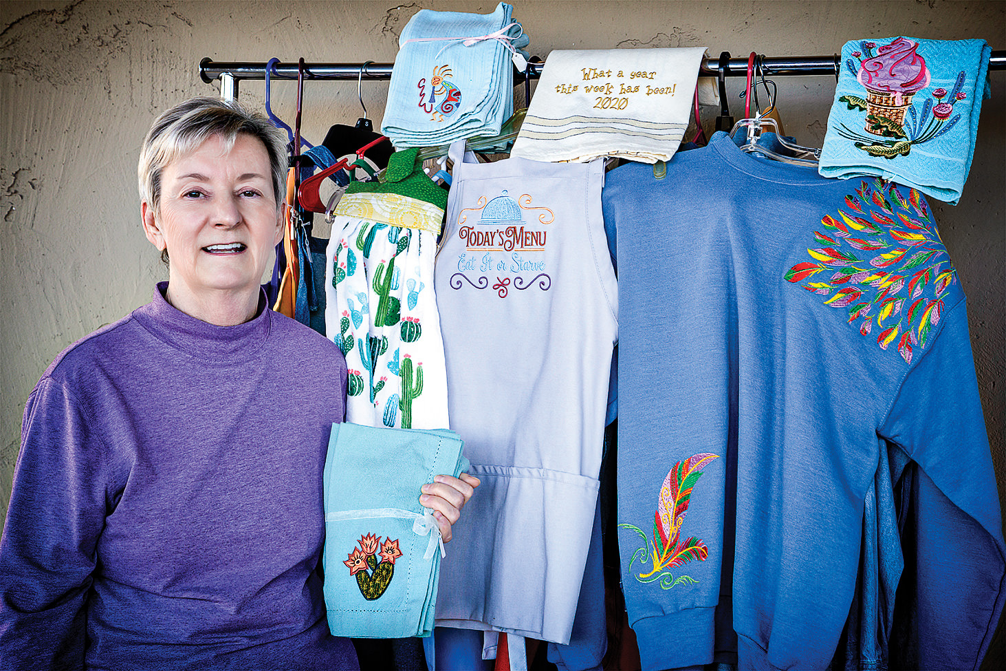 Kathy presenting some of her embroidery creations (Photo by Russell C. Stokes)