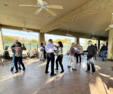 Dancing at the tennis pavilion—outdoors, socially distanced, and with masks.
