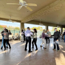 Dancing at the tennis pavilion—outdoors, socially distanced, and with masks.