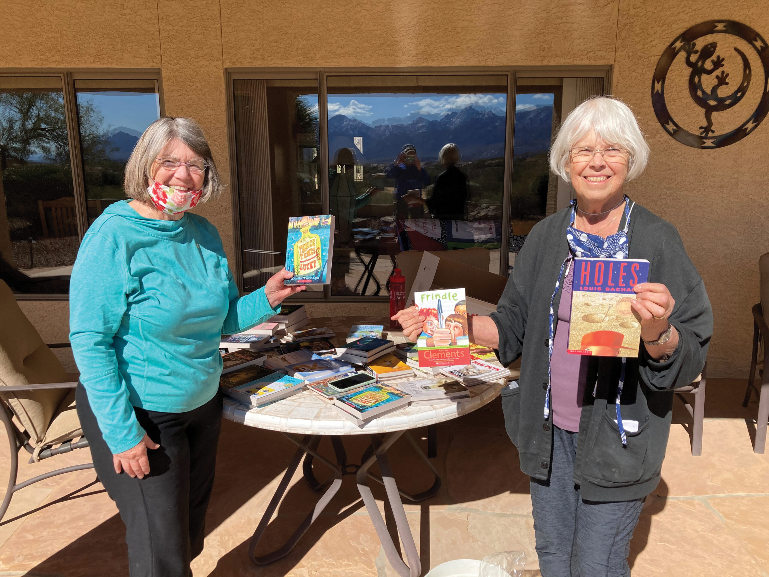 Patty See and Mary Thompson prepare books for teachers’ classroom libraries.