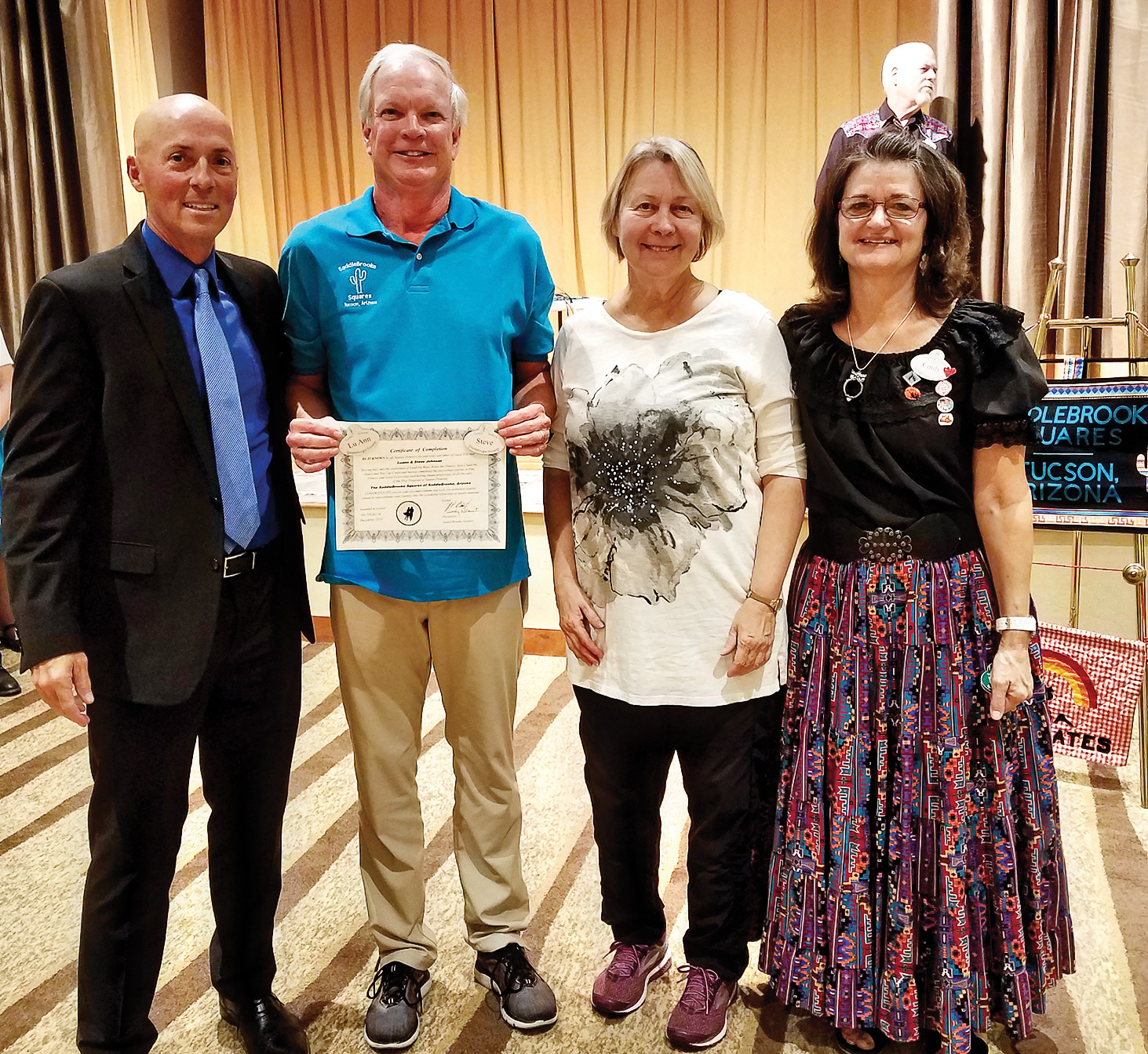 Steve and LuAnn Johnson (center) getting their square dance graduation certificate from J.P. Blount (left) and Cindy Blount (right)