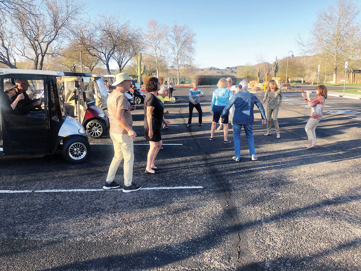 A whole lotta happy going on! The senior movers and shakers continue the lesson to dance like nobody's watching on The Preserve parking lot playground. (Photo by Gary Lange)