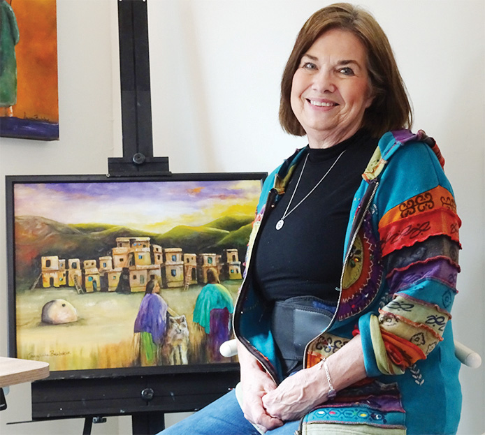 Suzanne Brubaker pauses in her studio with an in-progress work. (Photo by LaVerne Kyriss)