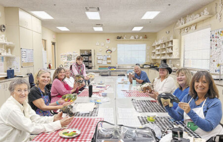 Introductory class students show off their Fetish Bear masterpieces.