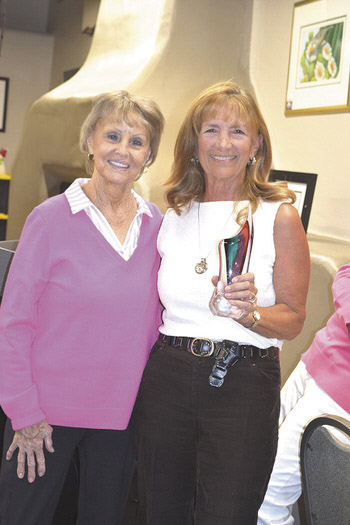 Sherry Fitzpatrick awarding the trophy to Carol Evans
