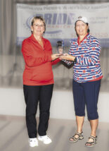 Lori Stegink receives the 2025 cup from Cathy Quesnell