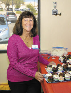 Marcia Kovac displays cupcakes baked by Joann Bosworth and Donna Twining