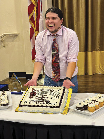 Outgoing Conductor Jesus Jacquez with his music themed cake.
